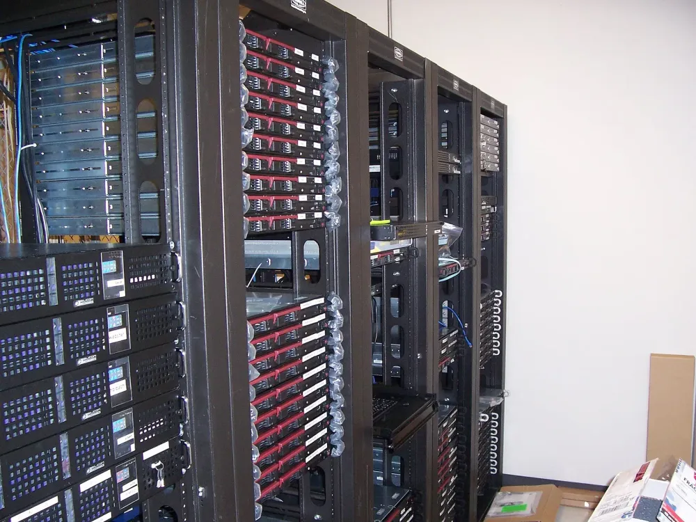 Several black server racks filled with computer hardware in a data center.