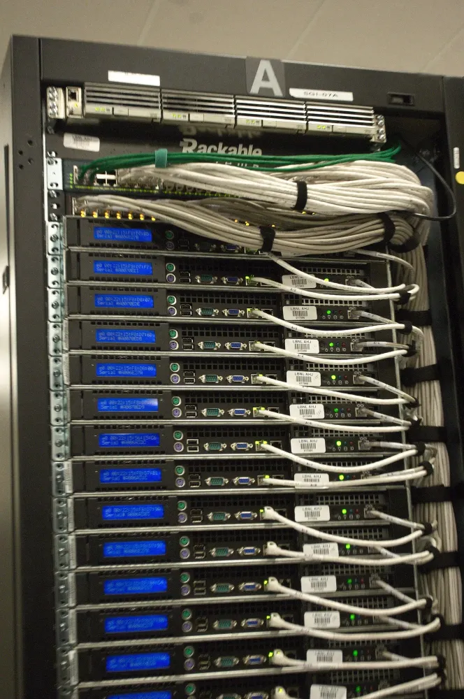 A server rack filled with multiple mounted server units and connected cables.